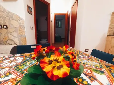 a vase of flowers sitting on top of a table at Ai Normanni in Palermo