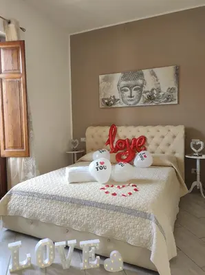 a bedroom with a bed with red bows on it at Mary Gery's Rooms in Castellammare del Golfo