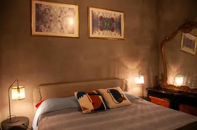 a bedroom with a bed with a yellow and orange blanket at Villetta Cicciuli in Altavilla Milicia
