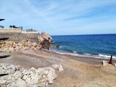 a group of rocks on a beach near the water at Villetta Cicciuli in Altavilla Milicia