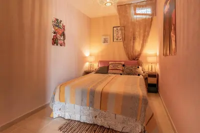 a small bedroom with a bed with two lamps at Villetta Cicciuli in Altavilla Milicia