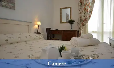 a hotel room with a bed with a tray with towels at Catarin Comfort Rooms in Castelluzzo