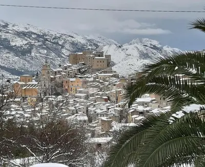 a town covered in snow on a mountain at La casa del custode in Caccamo