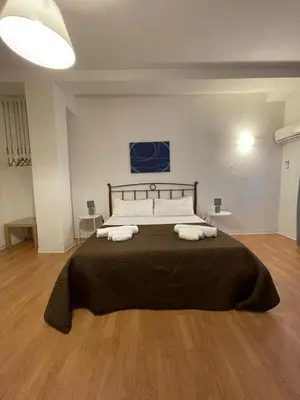 a bedroom with a large bed with two towels on it at 100 PASSI Politeama in Palermo