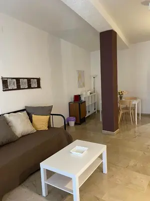 a living room with a couch and a table at 100 PASSI Politeama in Palermo
