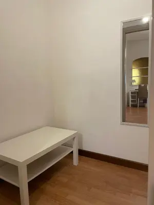 a white bench in a room with a mirror at 100 PASSI Politeama in Palermo