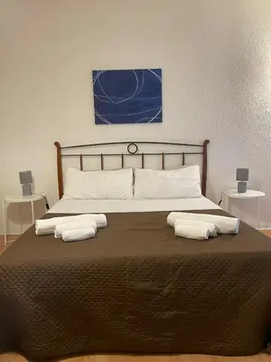 a large bed with two towels on top of it at 100 PASSI Politeama in Palermo