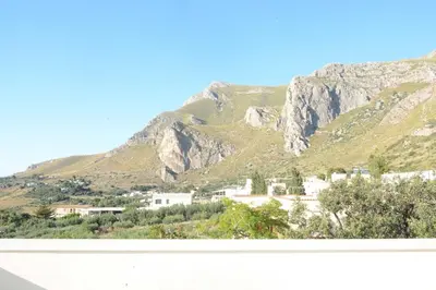 a view of a mountain with a town and houses at I colori del mare in Macari