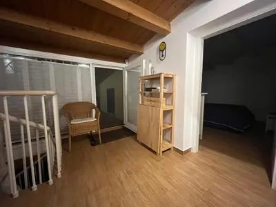 a room with a bed and a chair and a book shelf at Maquedino holiday home & Terrace - Cozy Central Loft in Palermo