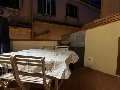 a table and two chairs in a room with a table and a table at Maquedino holiday home & Terrace - Cozy Central Loft in Palermo