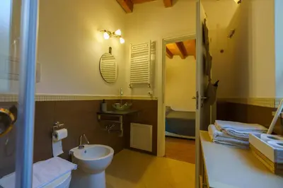 a bathroom with a toilet and a sink at Maquedino holiday home & Terrace - Cozy Central Loft in Palermo