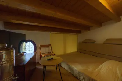 a bedroom with a bed and a desk and a chair at Maquedino holiday home & Terrace - Cozy Central Loft in Palermo