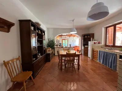 a kitchen and dining room with a table and chairs at Villa Barone in Castellammare del Golfo