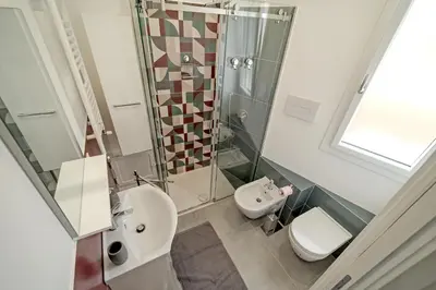 a bathroom with a shower and a sink and a toilet at AL BAYDA in Palermo