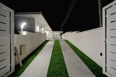 a long hallway with grass on the side of a building at AL BAYDA in Palermo