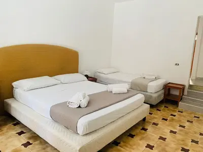 a bedroom with two beds with towels on them at Bonorum Santa Sofia in Palermo