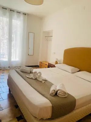 a bedroom with a large bed with towels on it at Bonorum Santa Sofia in Palermo