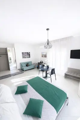 a living room with a large bed and a table at Maqueda Suites in Palermo