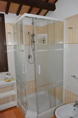 a shower with a glass door in a bathroom at Appartamento Casa Magnolia in San Vito lo Capo