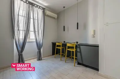 a bathroom with a white sink and a mirror at Dante Design Apartment by Wonderful Italy in Palermo