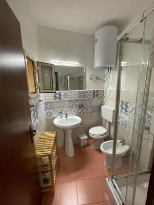 a bathroom with two toilets and a sink at La Zisa Holiday in Palermo