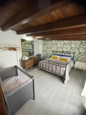 a bedroom with two beds and a mirror at La Zisa Holiday in Palermo