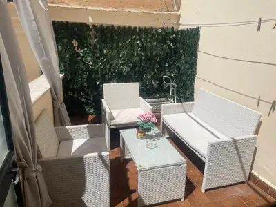 a group of chairs and a table on a patio at La Zisa Holiday in Palermo