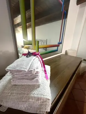 a pile of towels sitting on top of a table at La Zisa Holiday in Palermo