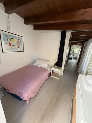 a bedroom with a bed and a wooden floor at La Zisa Holiday in Palermo