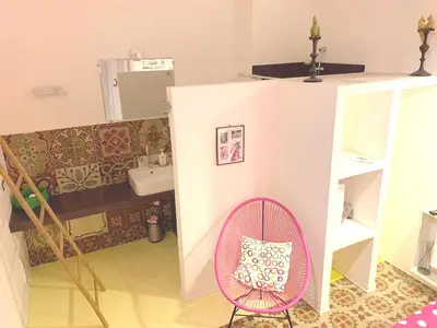 a small room with a pink chair and a bathroom at Apartment in Castellammare del Golfo - Sea View - 70 sqm C in Castellammare del Golfo