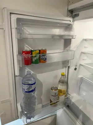 an open refrigerator with a bottle of water and drinks at Un Raggio di Sole al Massimo in Palermo