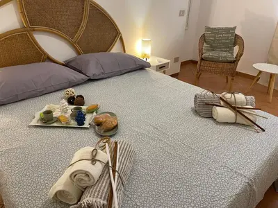 a bedroom with a large bed with food on it at Casa vacanze Baglio Barcellona Mondello in Palermo