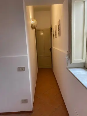 a hallway with a green door and a tile floor at Casa vacanze Baglio Barcellona Mondello in Palermo