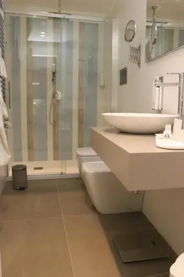 a bathroom with a toilet and a sink and a shower at meloluxuryhouse in Palermo