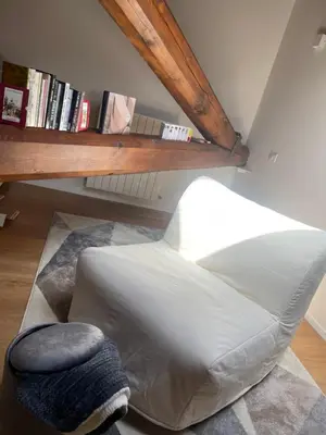 a white bed in a room with a book shelf at meloluxuryhouse in Palermo