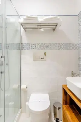 a bathroom with a toilet and a shower and a sink at Cortile Marconi Apartment in Palermo