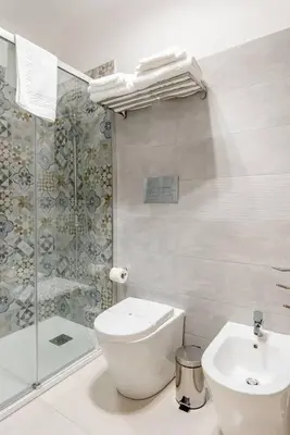 a bathroom with a toilet and a shower and a sink at Cortile Marconi Apartment in Palermo