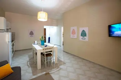 a kitchen with a table and a dining room at Le case di Sofia in Isola delle Femmine