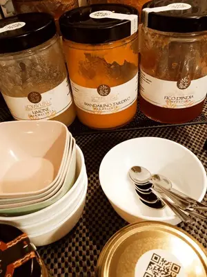 a group of dishes and spoons on a table at LA DAMA in San Vito lo Capo
