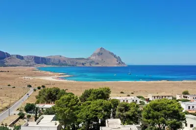 a view of a beach with a mountain in the background at LA DAMA in San Vito lo Capo
