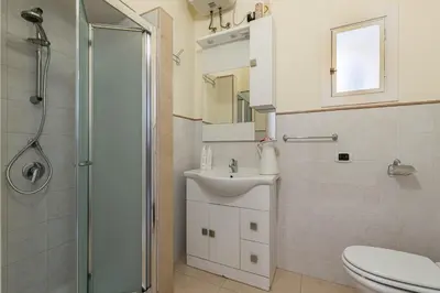 a bathroom with a shower and a sink and a toilet at Olivella Apartment al Teatro Massimo by Wonderful Italy in Palermo