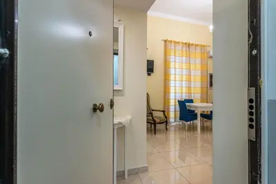 a door leading to a room with a table and chairs at Olivella Apartment al Teatro Massimo by Wonderful Italy in Palermo