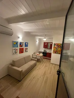 a living room with a couch and a table at Surfinia’s home in Palermo