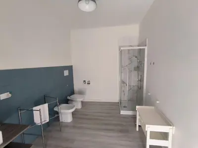 a bathroom with two toilets and a shower at B&B Puvogel in Porticello