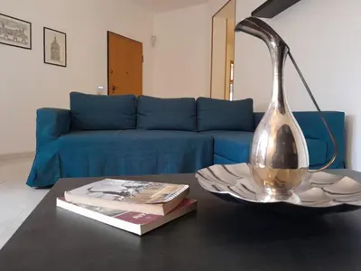 a kitchen and dining room with a refrigerator and a table at Oasi home in Casteldaccia