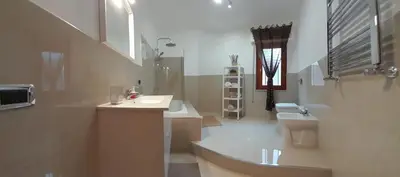 a living room with a couch and a chair and a table at Oasi home in Casteldaccia