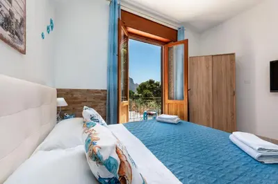 a bedroom with a large bed with a large window at Makari Our Angel in Macari