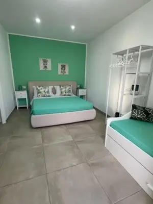 a white bench with a green top in a room at Makari Our Angel in Macari