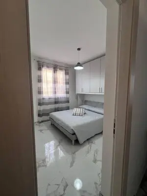 a bedroom with two beds and a green wall at Makari Our Angel in Macari
