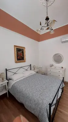 a bedroom with a bed and a ceiling at Elenahouse alla Kalsa in Palermo